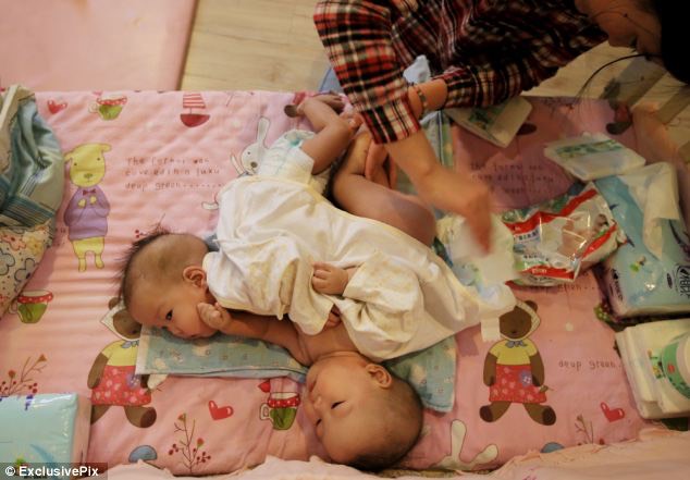 3. Staff at the Beijing children's home, where they are being cared for, said the girls were happy and 'lively'  - article-2520391-19F3C28300000578-193_634x441